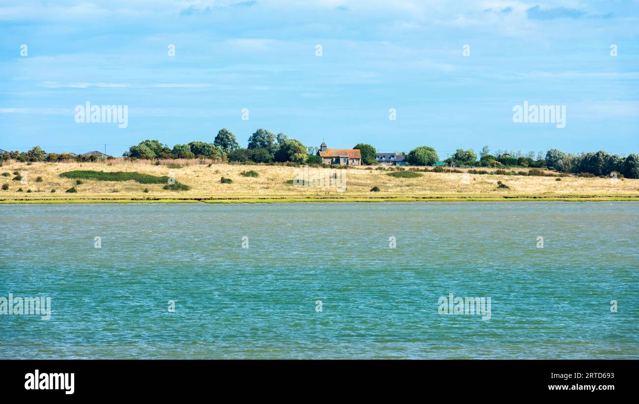 St Thomas the Apostle Church on the Isle of Sheppey viewed from Oare near Faverhsam across the Swale Estuary Stock Photo