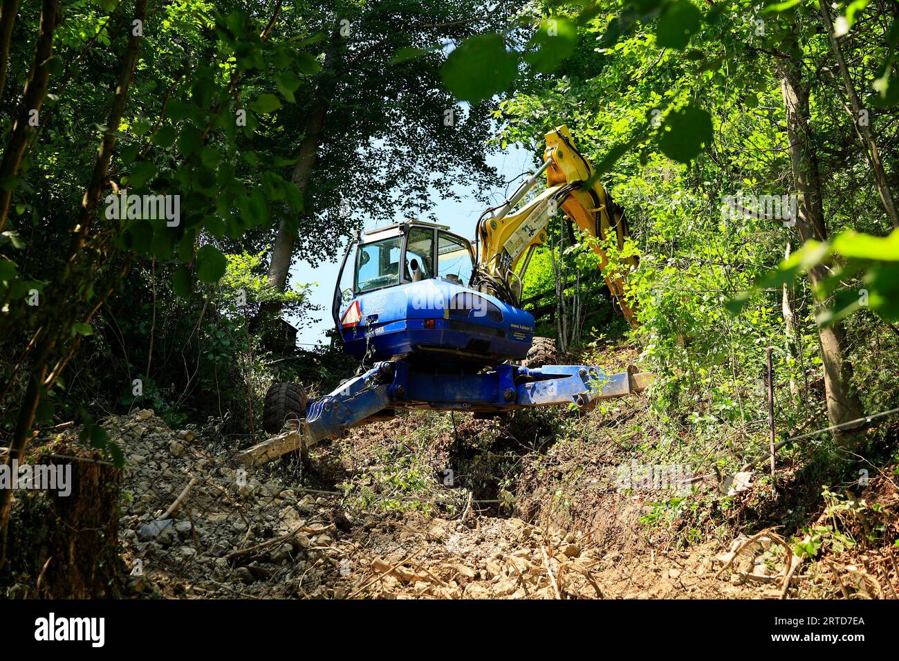 Excavator stands on a steep slope Stock Photo