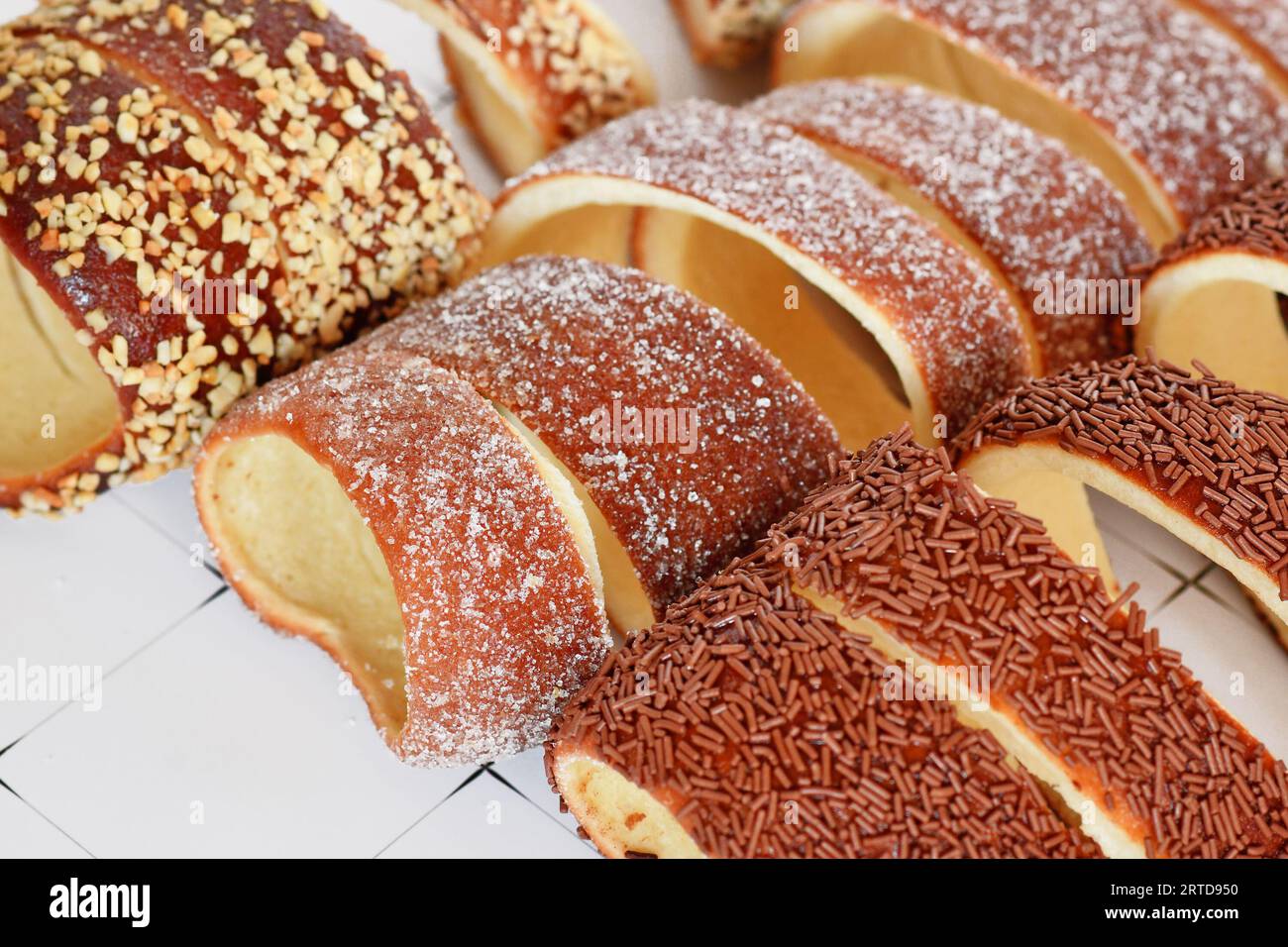 Close up of 'Kurtoskalacs', a spit cake from Hungary and Romania made from sweet yeast dough strips baked wrapped around cone–shaped baking spit Stock Photo