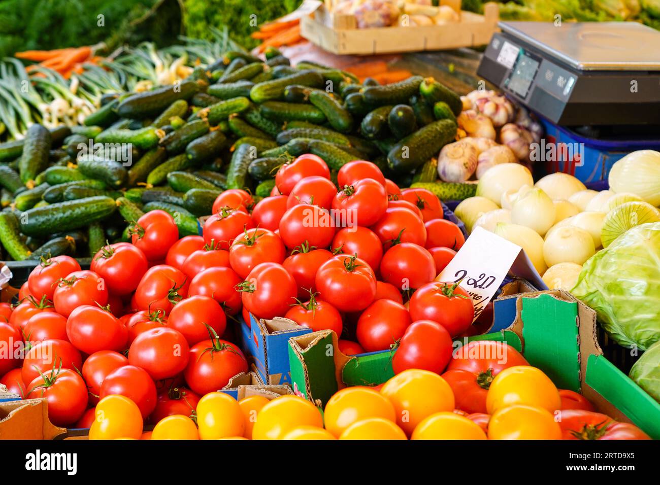 Various colorful fresh organic vegetables at a farmers market, tomatoes ...