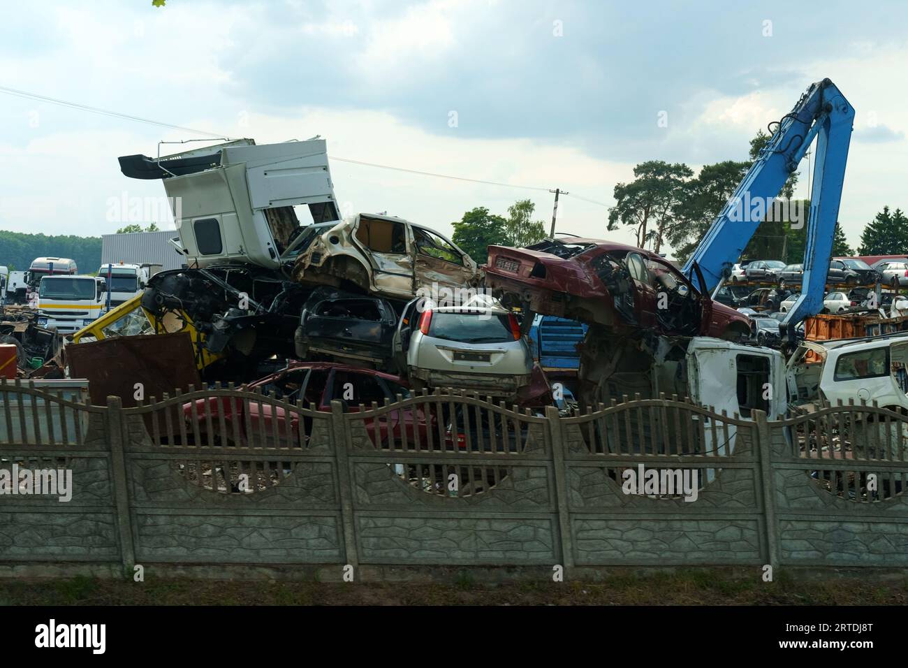 Mixed pile of scrap metal in a landfill - old car bodies suitable for recycling. Dump. Stock Photo