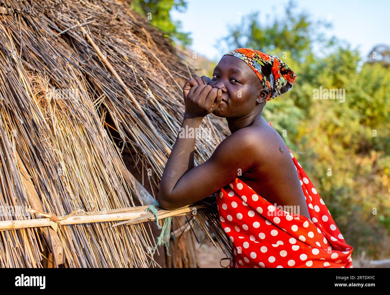 Didinga young woman stayng near her hut Stock Photo