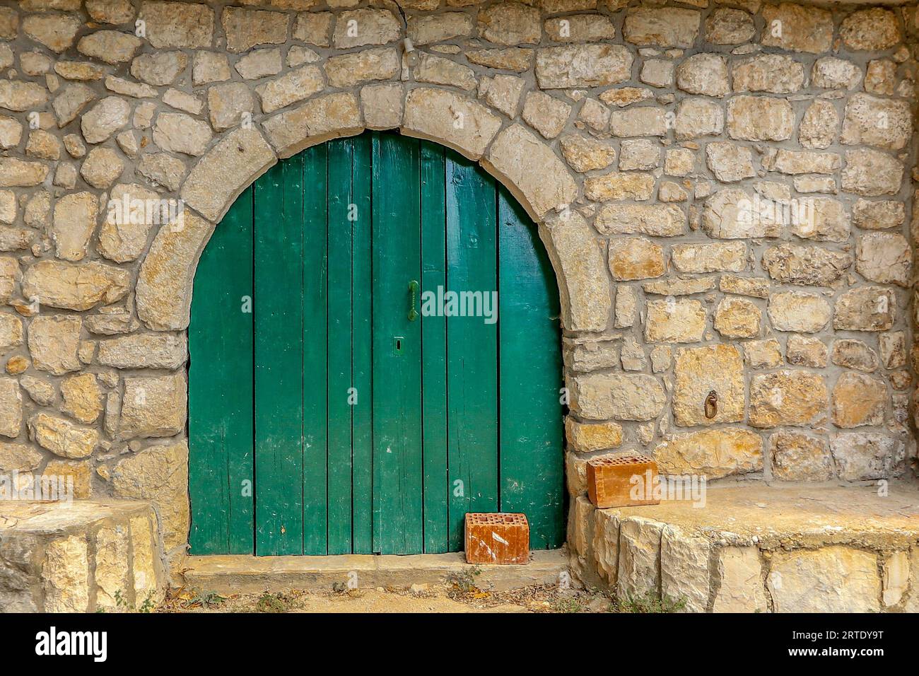 Old green door in a house of a village destroyed by an earthquake in Croatia Stock Photo