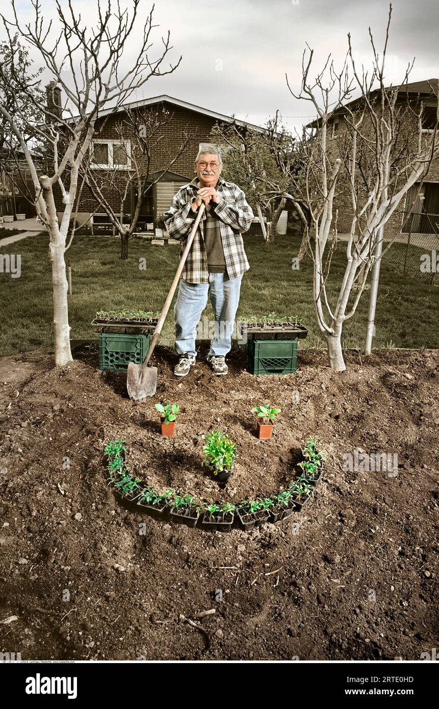 Man working in garden shoveling hi-res stock photography and images - Alamy