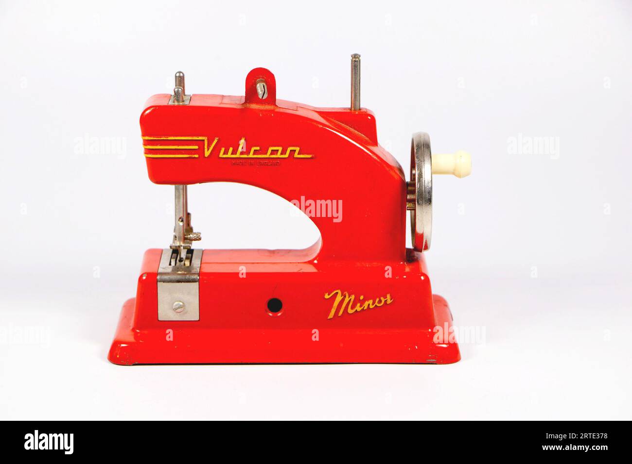 Red 1950's vintage Vulcan Minor sewing machine miniature toy child's sewing machine isolated against a white studio background box Stock Photo