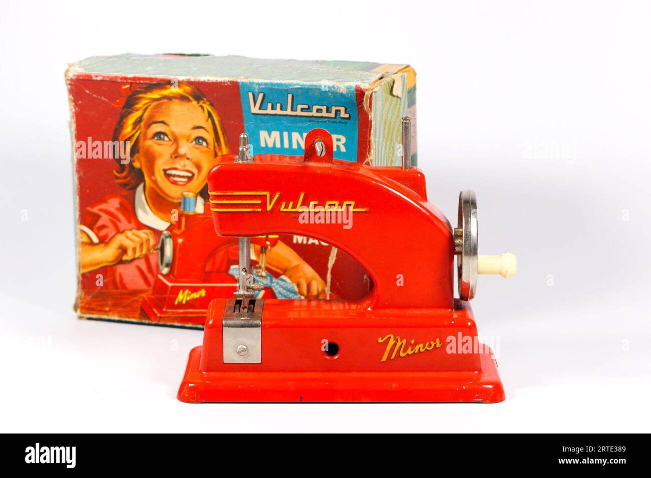Red 1950's vintage Vulcan Minor sewing machine miniature toy child's sewing machine isolated against a white studio background box Stock Photo