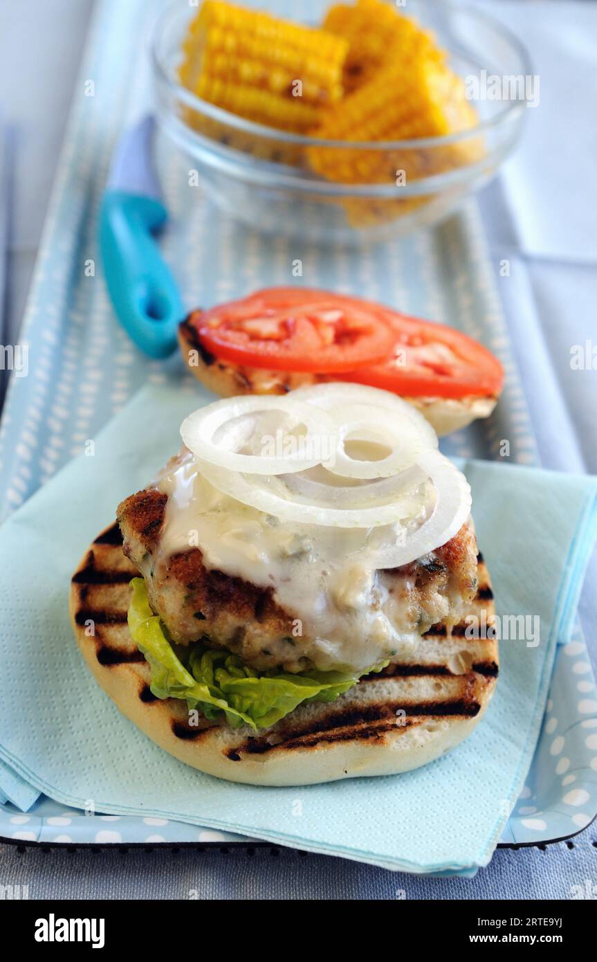 Chicken burger with bluecheese sauce and sweetcorn Stock Photo - Alamy