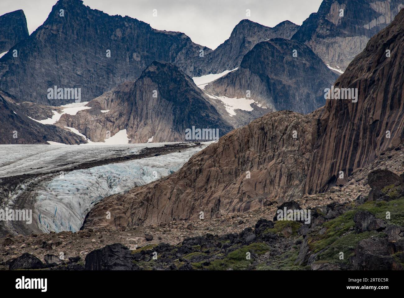 View of glacier flowing through the mountain peaks in Prins Christian Sund at the Southern tip of Greenland; Southern Greenland, Greenland Stock Photo