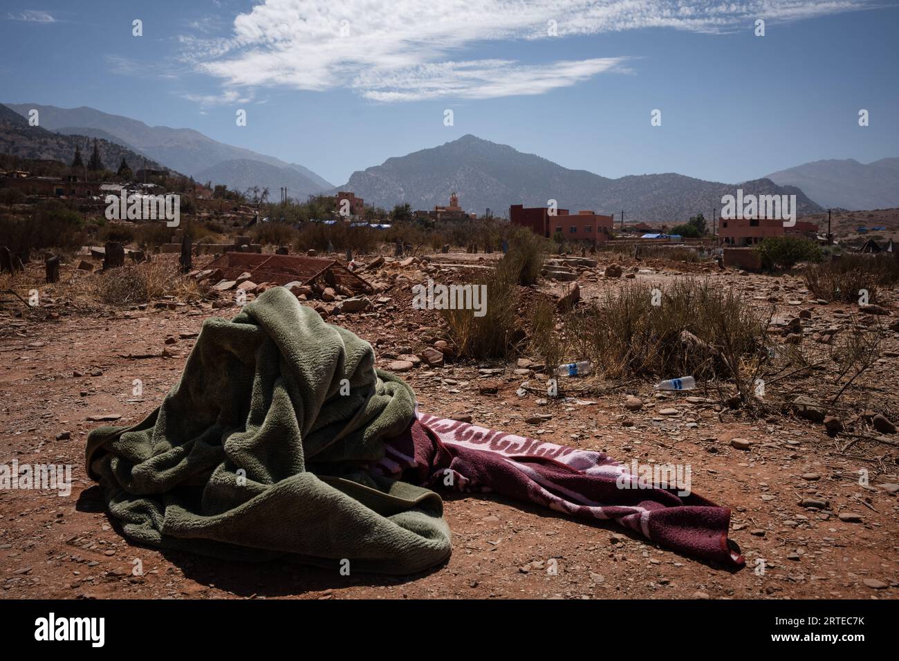 Blankets which carried dead bodies are seen laying next to some new