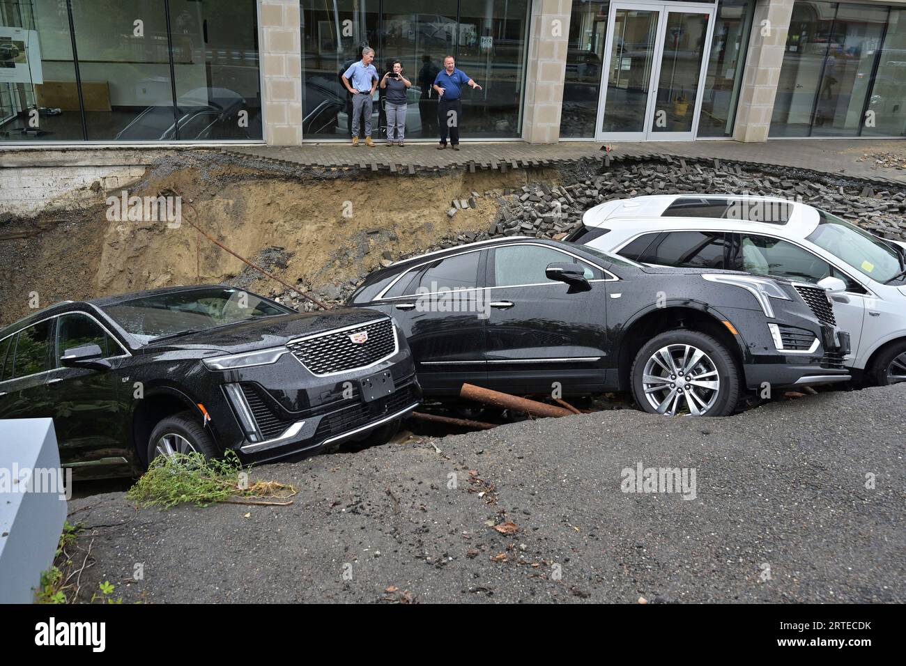 Rick Durand Owner of Durand Cadillac, left, and colleagues stand behind