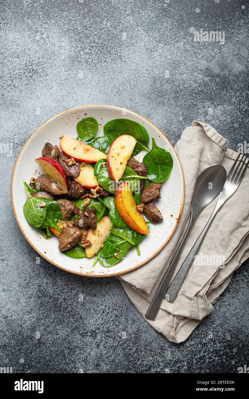 Healthy salad with ironrich ingredients Chicken liver, apples, spinach, and walnuts Stock