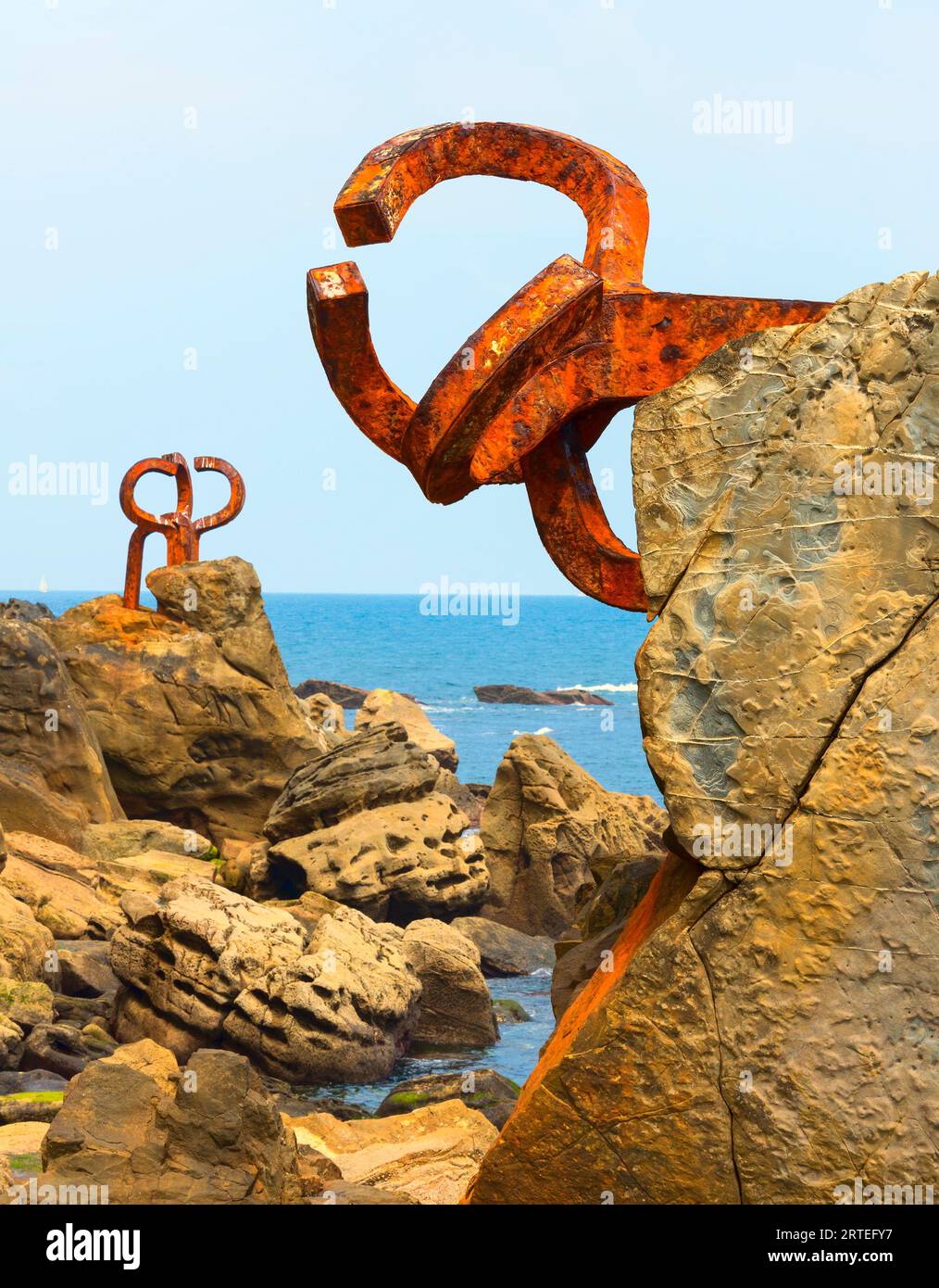 Bronze sculptures, Comb of the Wind by Eduardo Chillida, situated on the rocky shore of the Sea Resort Town of San Sebastian in Basque Country Stock Photo