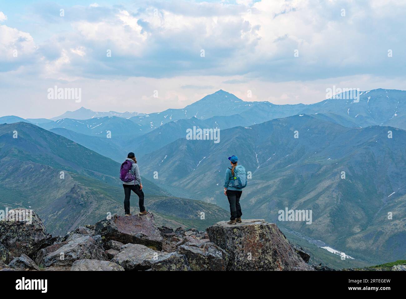 Two women on top of a mountain in the northern Yukon; Yukon, Canada Stock Photo