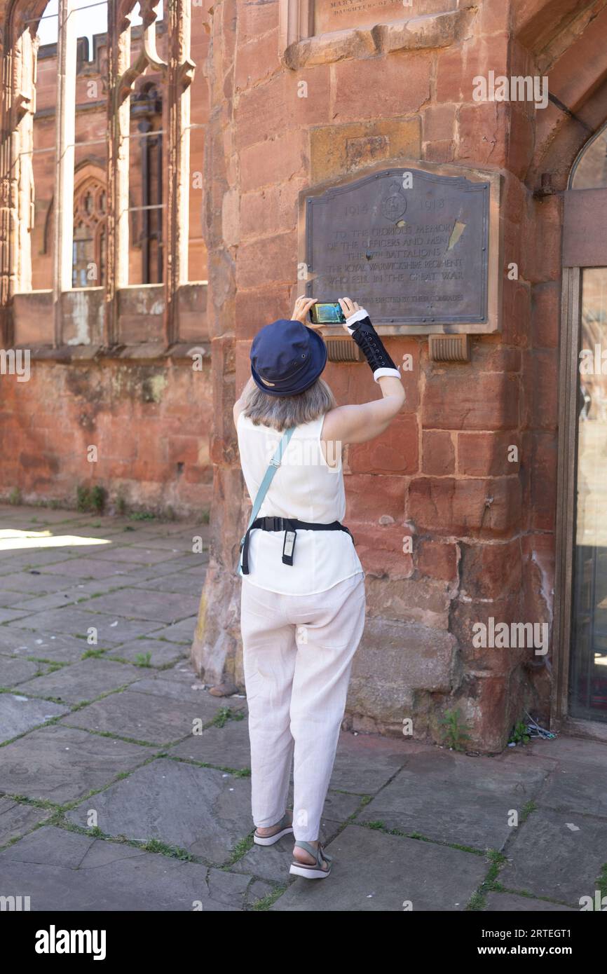 Mature woman uses her smart phone while exploring a historic site; United Kingdom Stock Photo