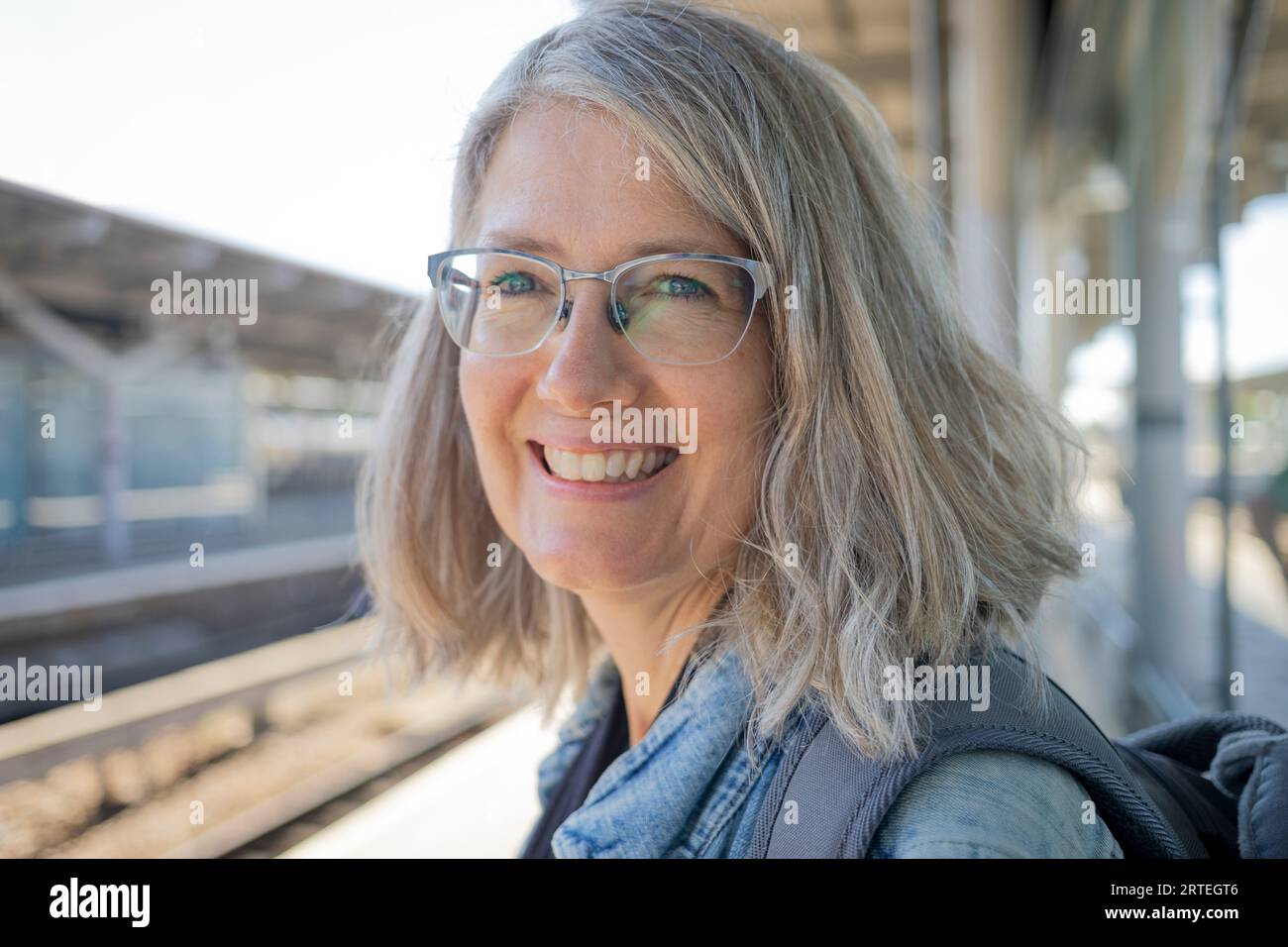 Close-up portrait of a mature woman waiting at a train station; United Kingdom Stock Photo