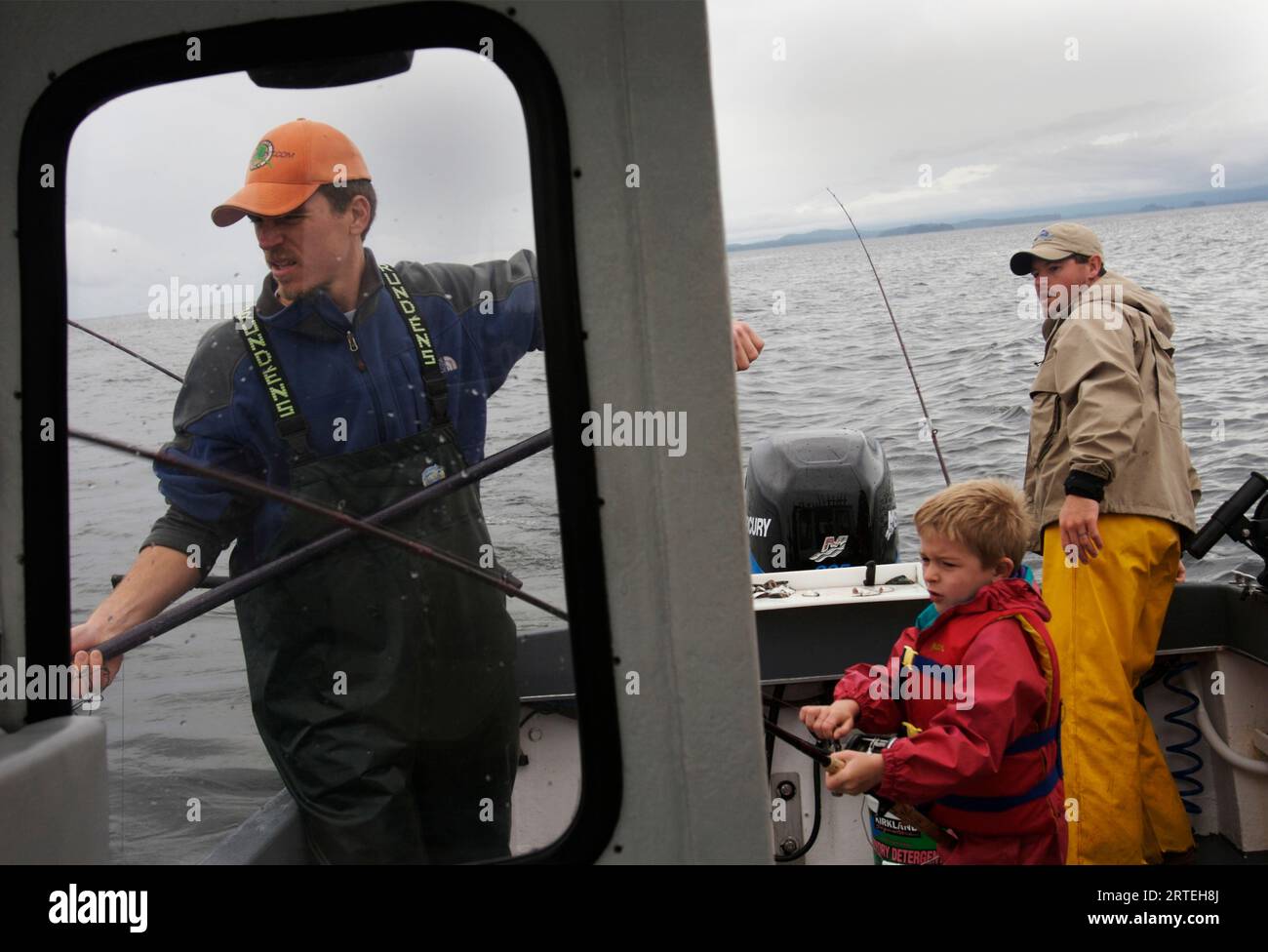 Men and boy fishing on Thorne Bay; Alaska, United States of America