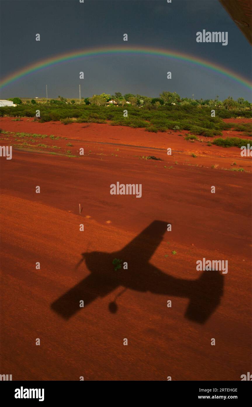 Rainbow and shadow of an airplane in the Kimberley Region of Western Australia; Halls Creek, Kimberley Region, Western Australia, Australia Stock Photo