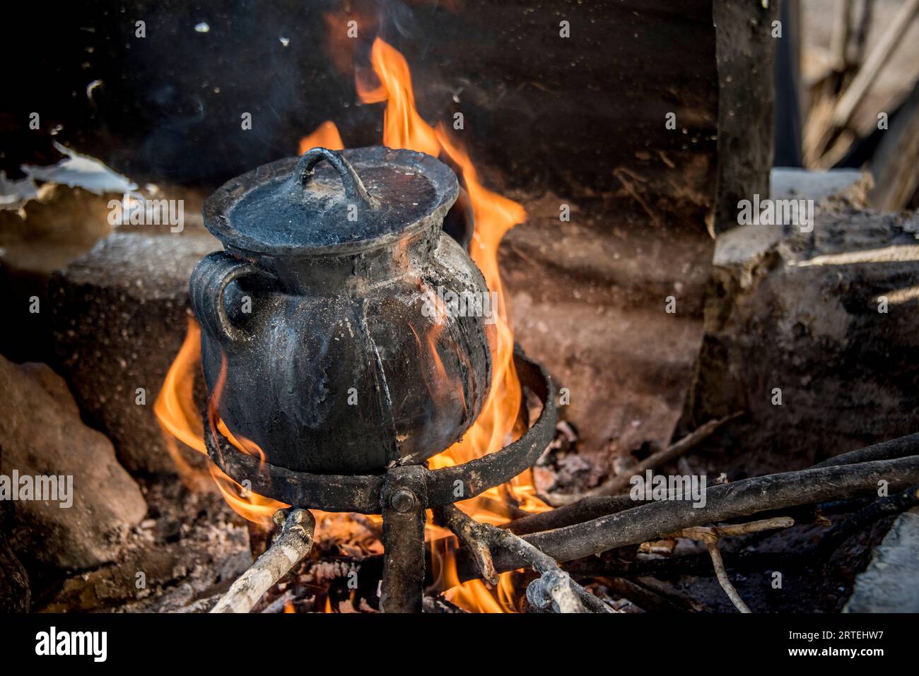 Cooking food in pot over an open flame; Ejido Hidalgo, San Luis, Mexico