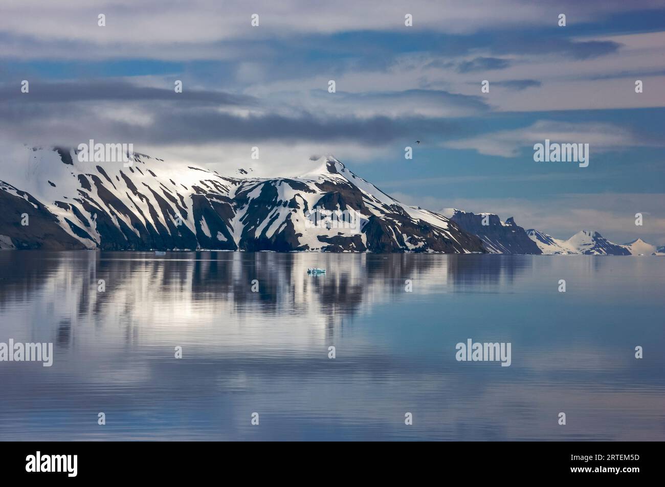 Mountain and cloud reflections in Storfjord; Svalbard Archipelago, Norway Stock Photo