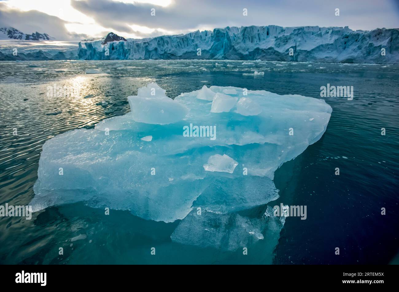 Blue iceberg floating in Lilliehook Fjord; Spitsbergen, Svalbard Archipelago, Norway Stock Photo