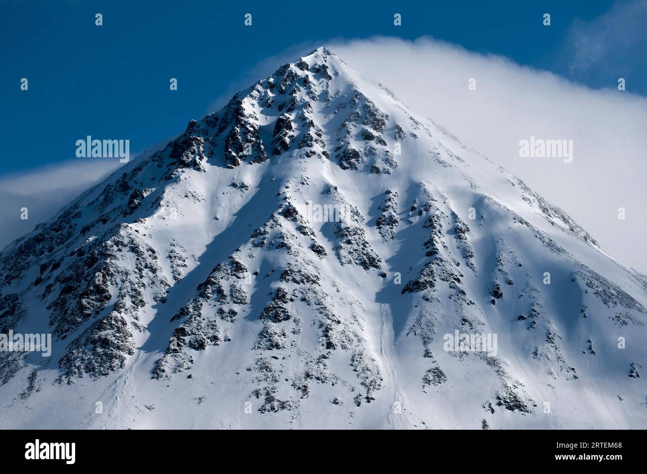 Cloud and spindrift on a mountain peak; Spitsbergen, Svalbard Archipelago, Norway Stock Photo