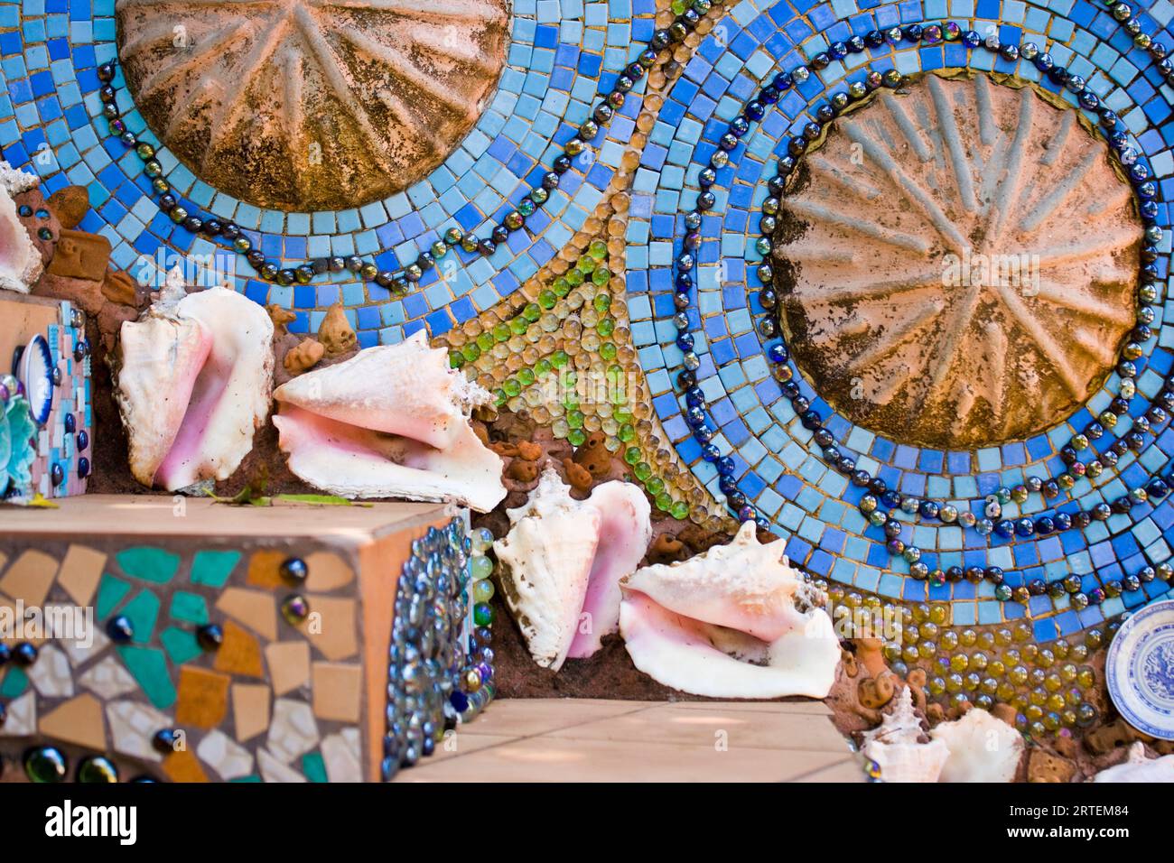 Conch shells decorate steps covered in a colourful mosaic; Utilla, Honduras Stock Photo