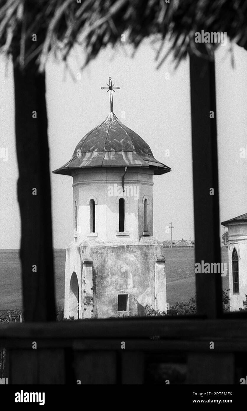 Măgureni, Calarasi County, Romania, 1990. Abandoned old church in a village near Bucharest. The bell tower of the church of Magureni, a historical monument from the 17th century, was inundated in 1983, during the works at the Danube–Bucharest Canal, a project of the Romanian president N. Ceausescu. Stock Photo