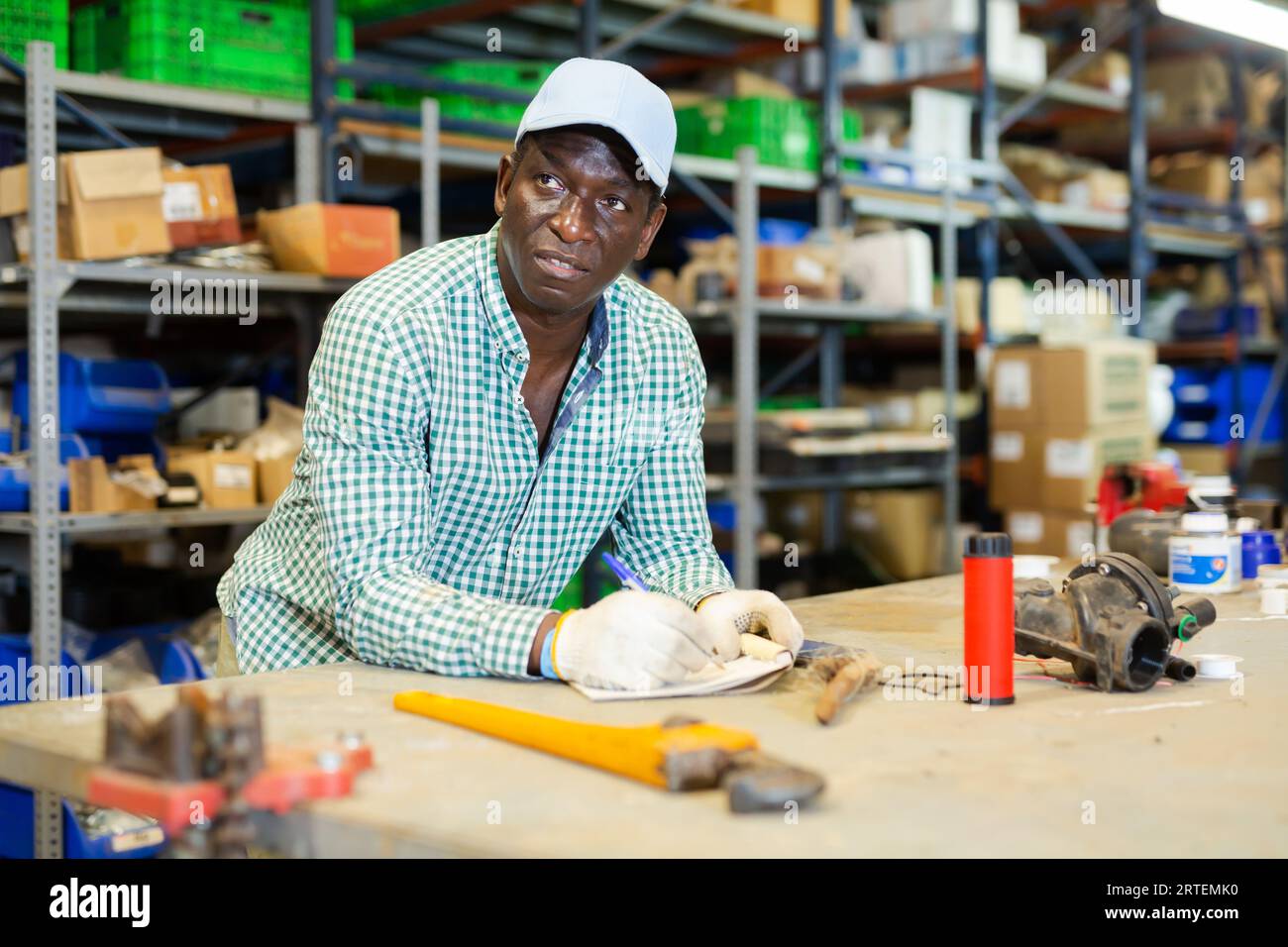 Portrait of focused African-American man worker checking order list Stock Photo