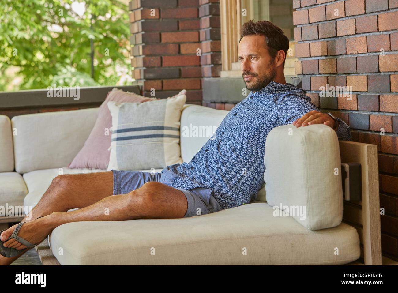 Mid adult man reclining hi-res stock photography and images - Alamy