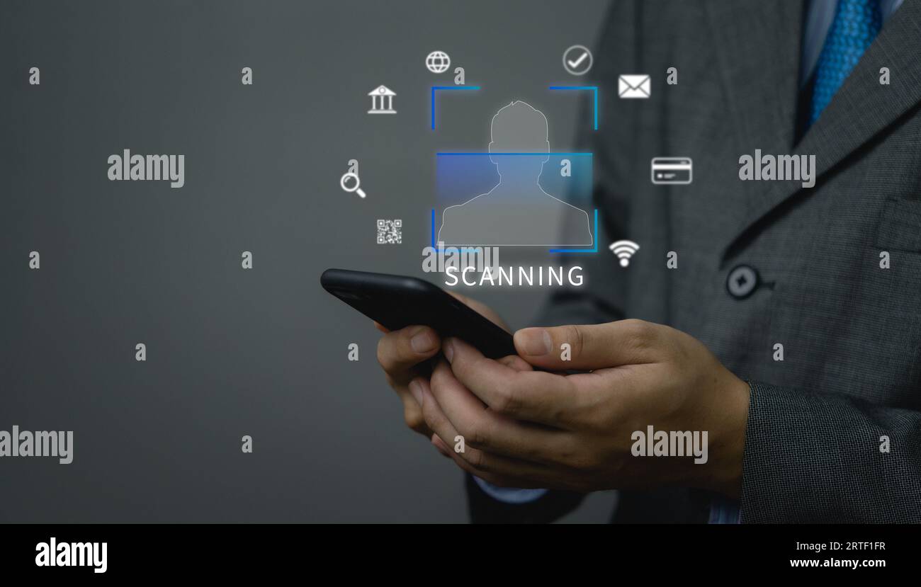 businessman holding mobile phone icon, scan face and identity verification.Payment and anti-theft and online security protection, finance and work, te Stock Photo