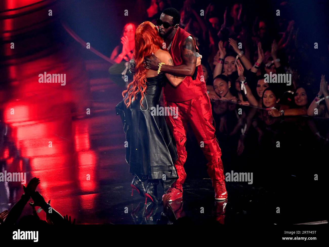 Keyshia Cole and Diddy hug after performing on stage at the MTV Video