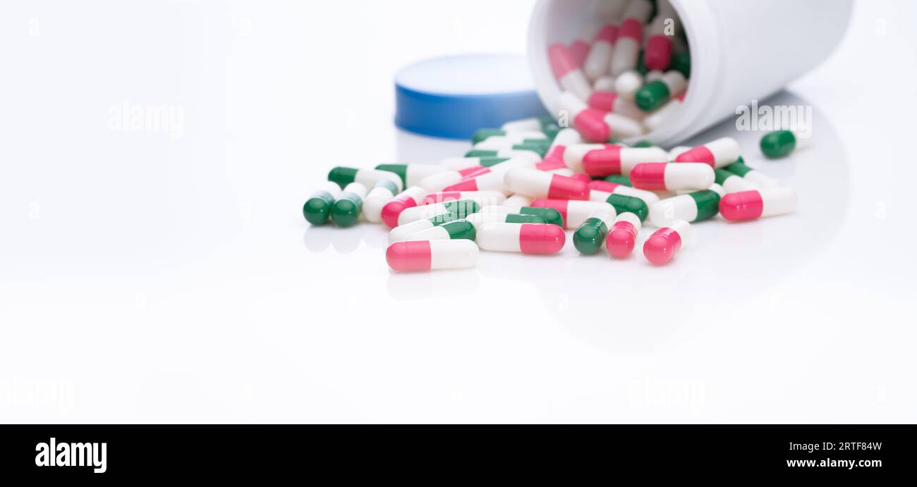 Antibiotic capsule pills spread out of plastic bottle. Pharmaceutical industry. Antibiotic drug resistance concept. Prescription drugs. Health care Stock Photo