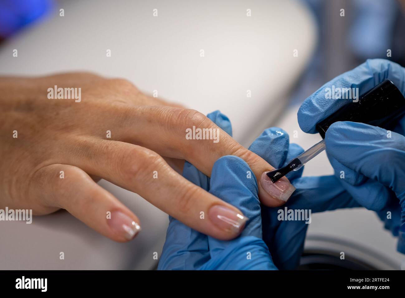 Nail care procedure in a beauty salon. Female hands and tools for