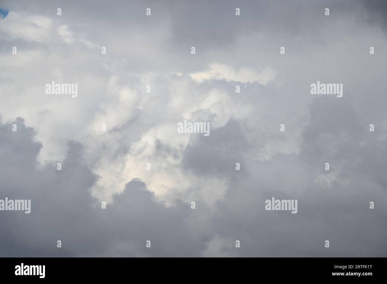 Dynamically changing and diverse layers of white clouds over the city. The clouds move quickly from left to right. Stock Photo