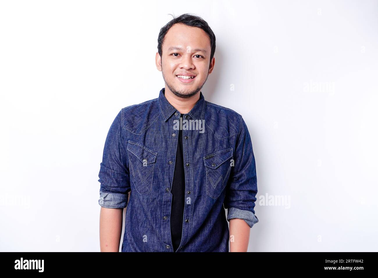 A portrait of a smiling Asian man dressed in a blue shirt, isolated by ...