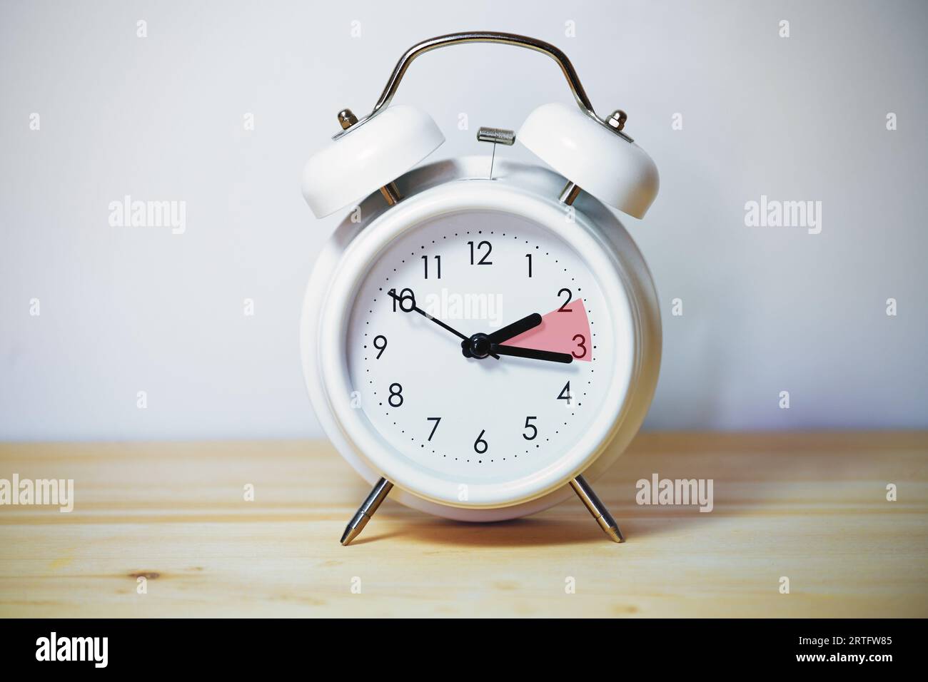 Vintage alarm clock showing change from daylight saving time and fall back to standard time, copy space, selected focus Stock Photo