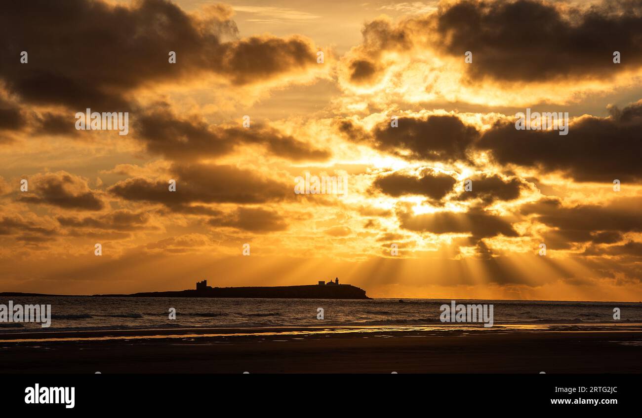 Bamburgh, Northumberland, UK. 13th September 2023. The sunrise over the Farne Islands from Bamburgh beach, Northumberland. Neil Squires/Alamy Live News Stock Photo