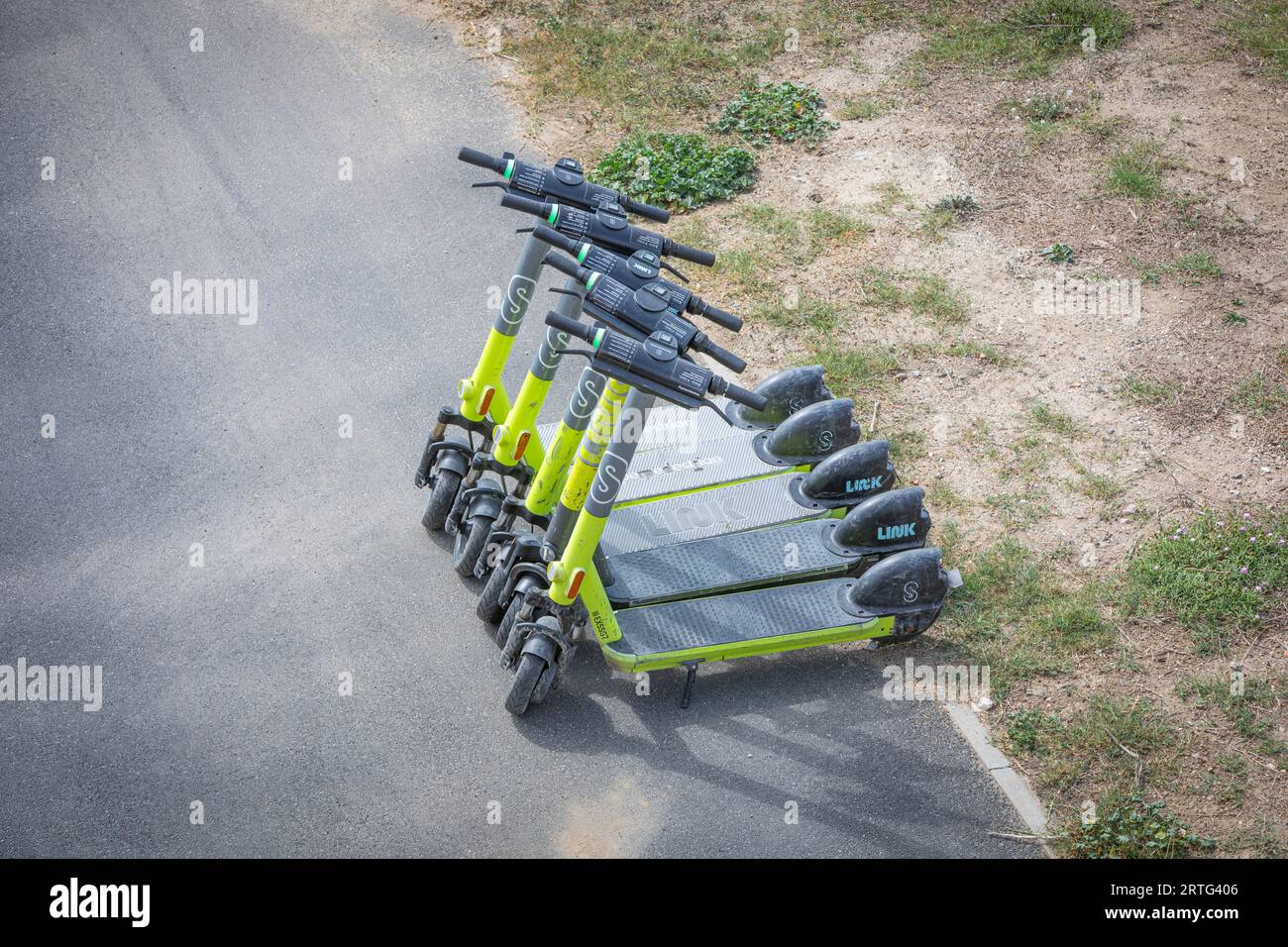 Electric scooters parekd by a roadside in Le Barcares, South of France Stock Photo