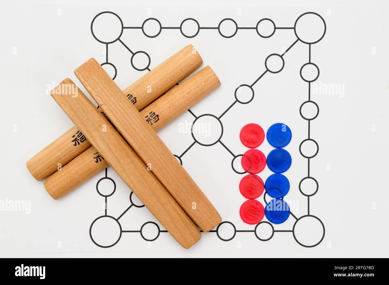 Yut is a traditional Korean board game that uses four wooden sticks called yut. Translation of Text : Good luck. Stock Photo