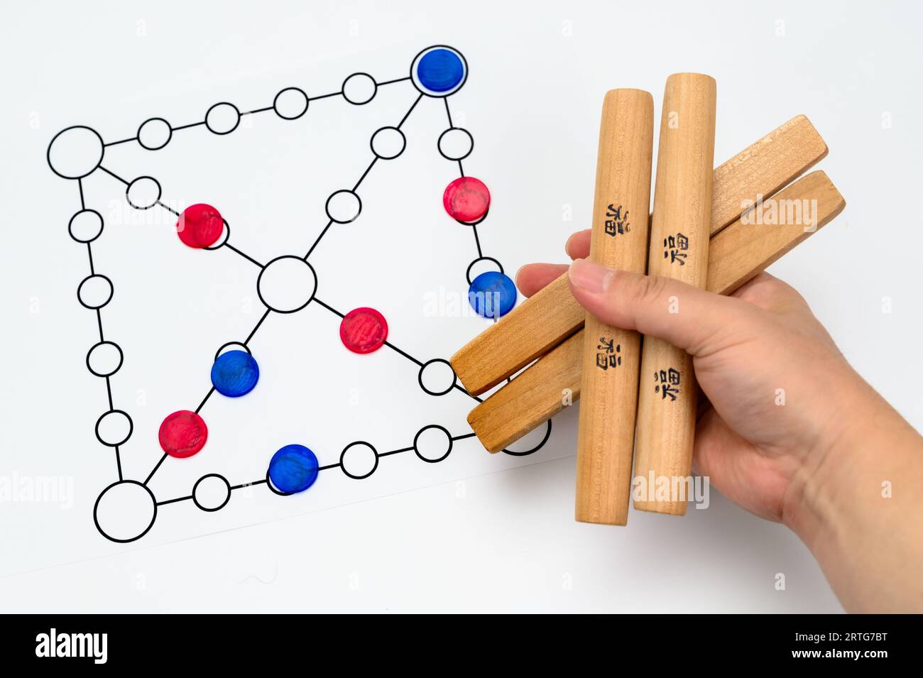 Yut is a traditional Korean board game that uses four wooden sticks called yut. Translation of Text : Good luck. Stock Photo