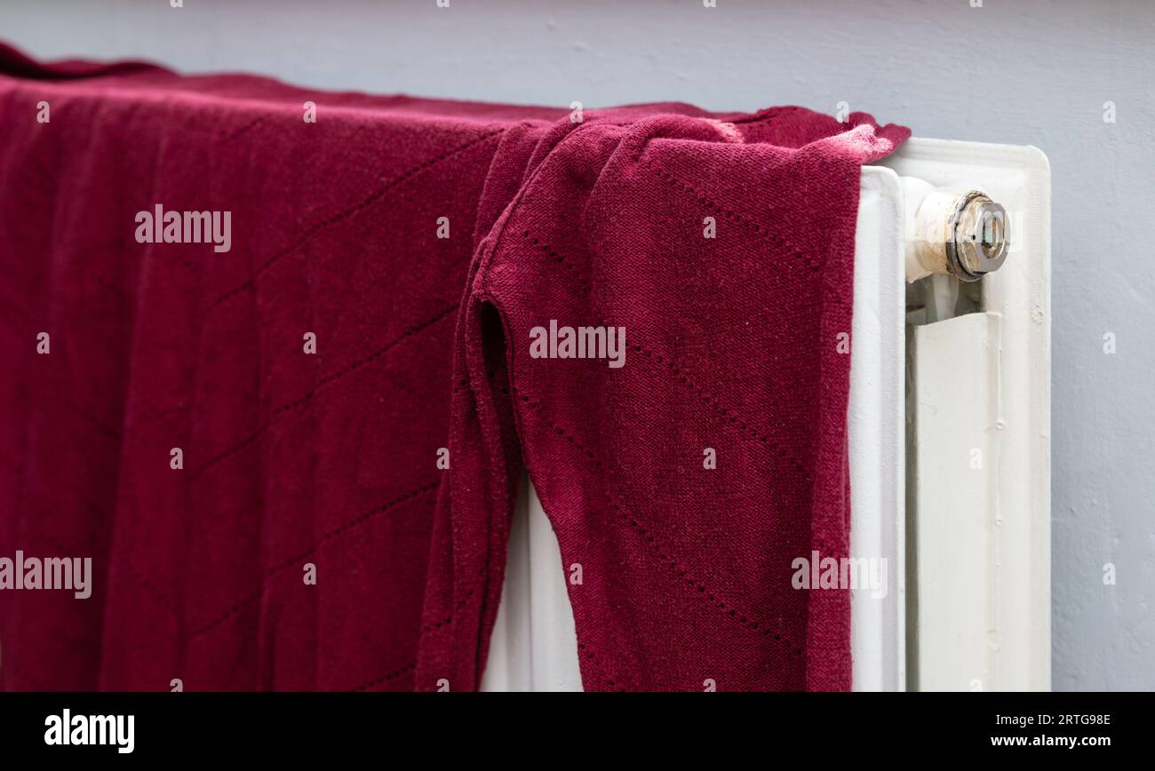 Washing drying on a radiator. Stock Photo