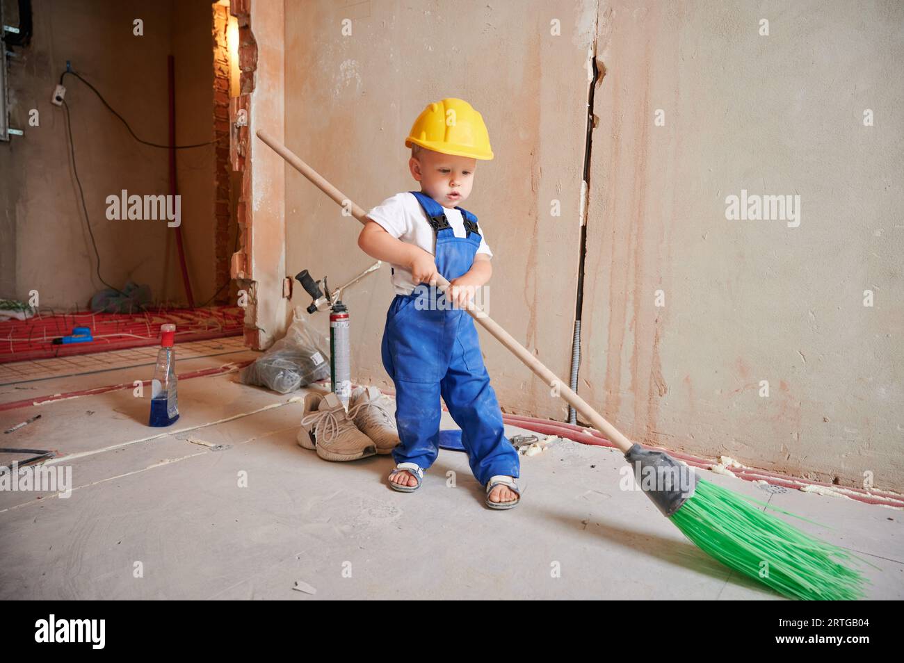 Young child doing house chores at home. Asian baby boy sweeping floor with  broom Stock Photo - Alamy