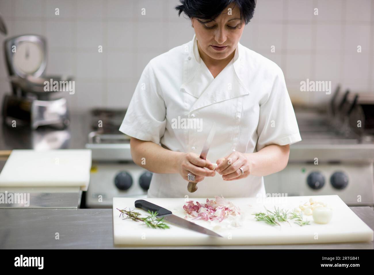 Woman peeling garlic knife hi-res stock photography and images - Alamy