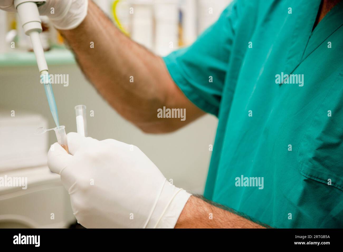 Healthcare professional holding a medical dropper Stock Photo Alamy