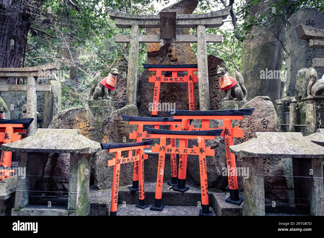 There are thousands upon thousands of orange colored torii gates and small alters along the pathway of Fushimi Inari Taisha in Kyoto, Japan. Stock Photo