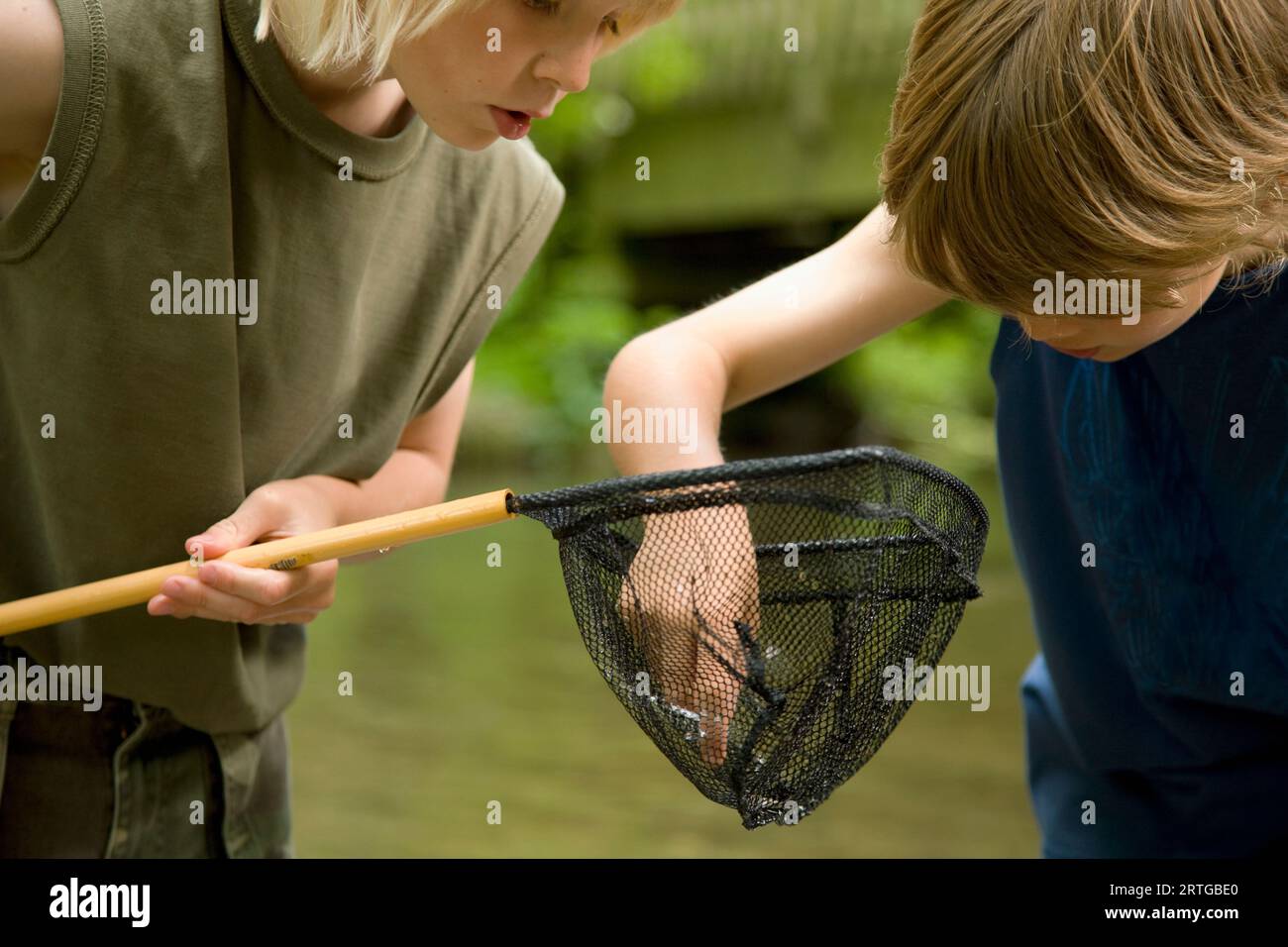 Young boy with fishing net hi-res stock photography and images