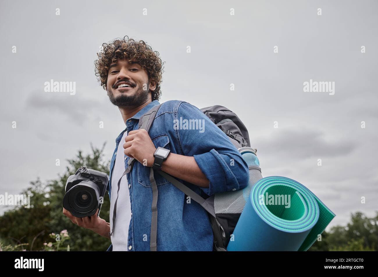 travel photography and nature concept, happy indian backpacker holding ...
