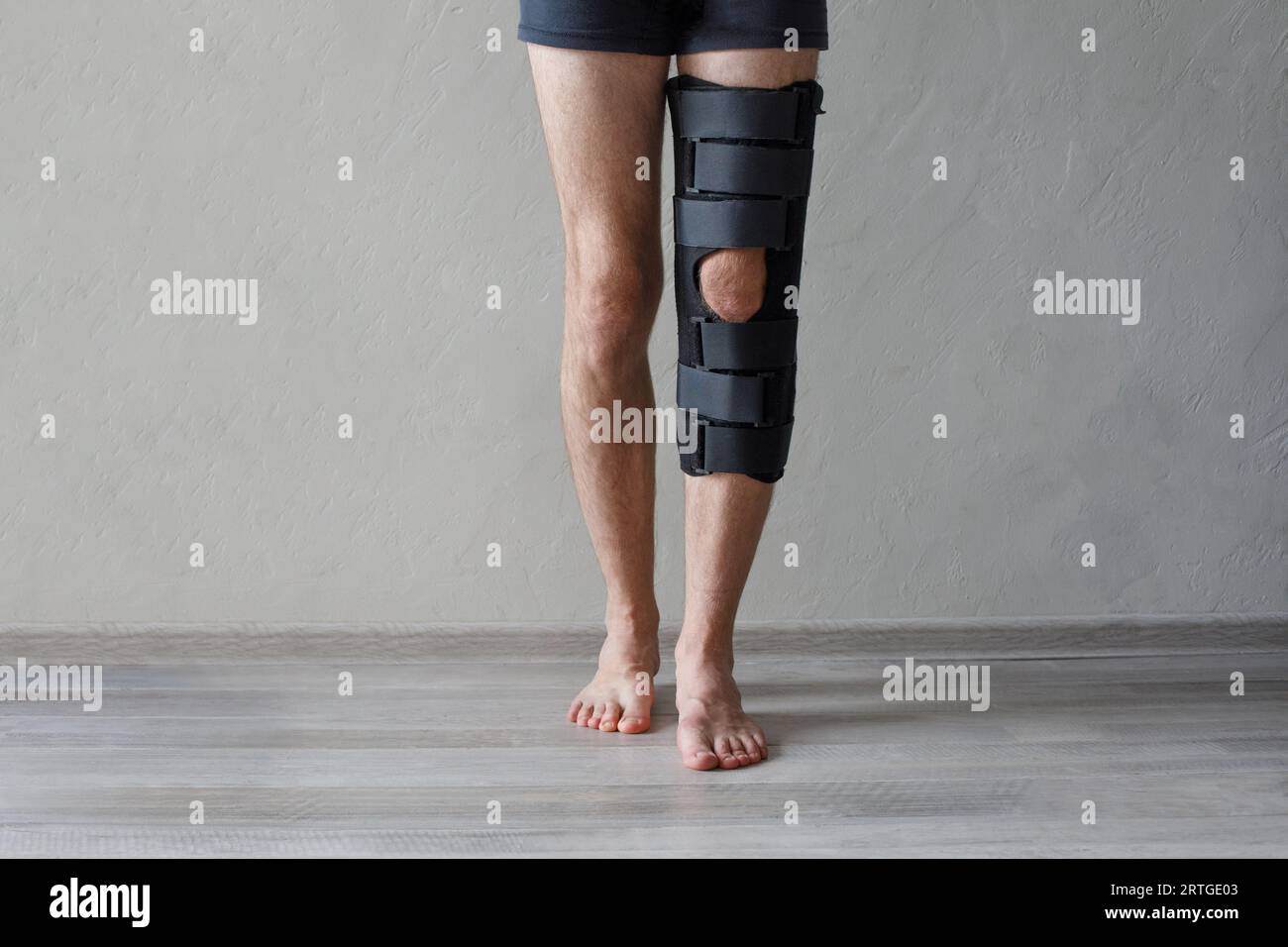 Patient standing with knee brace support after do posterior cruciate