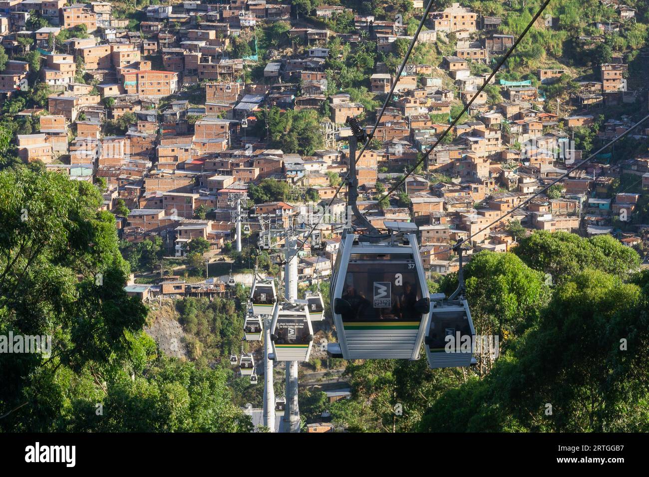 Cable car riding over informal neighbourhoods in Medellin, Antioquia, Colombia Stock Photo