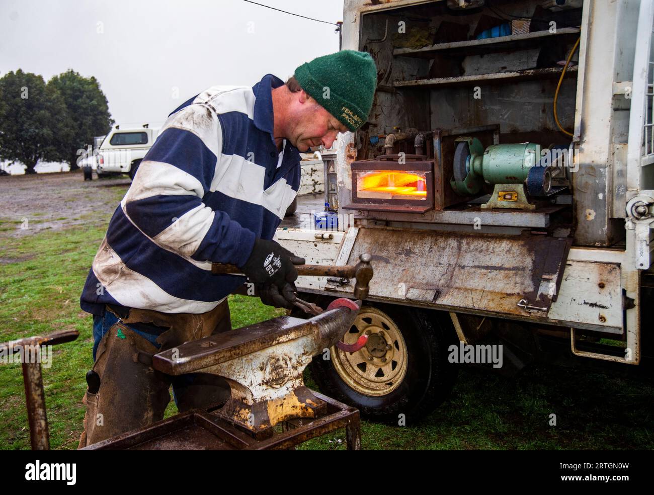 Horse farrier, Craig Robottom using a portable anvil and mobile truck